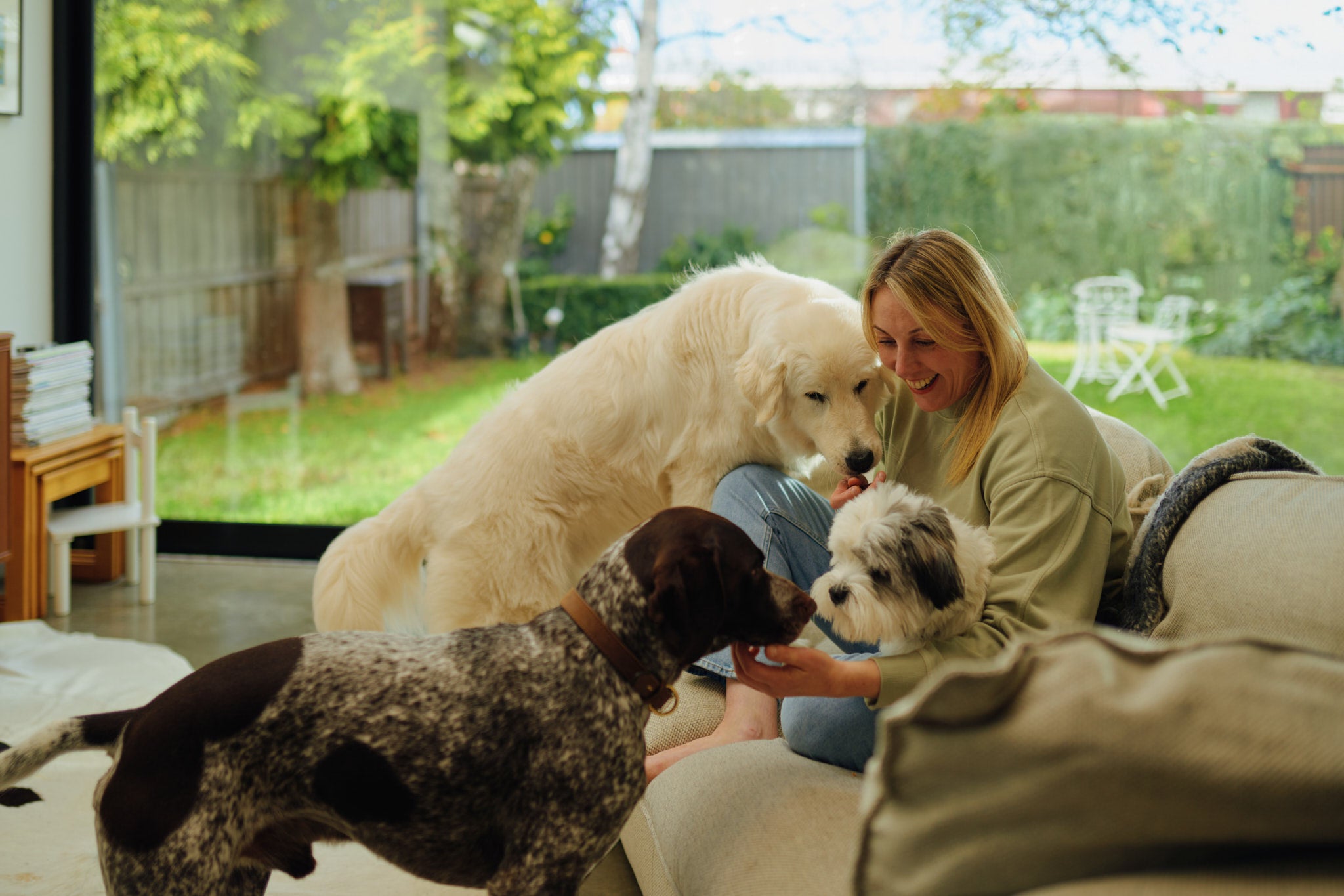 A woman on the sofa with her dogs