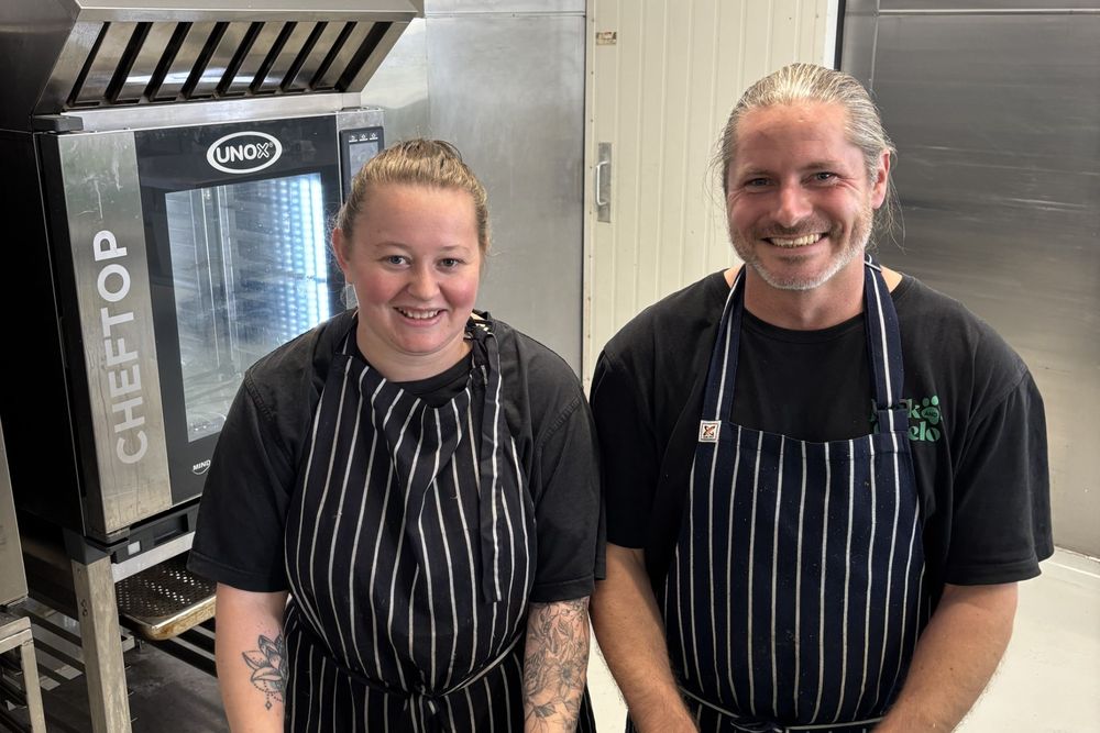 Two Jack and Chelo chefs in aprons in the Hobart kitchen